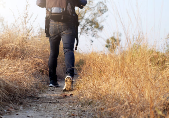 Oung Man Traveler with backpack relaxing outdoor.